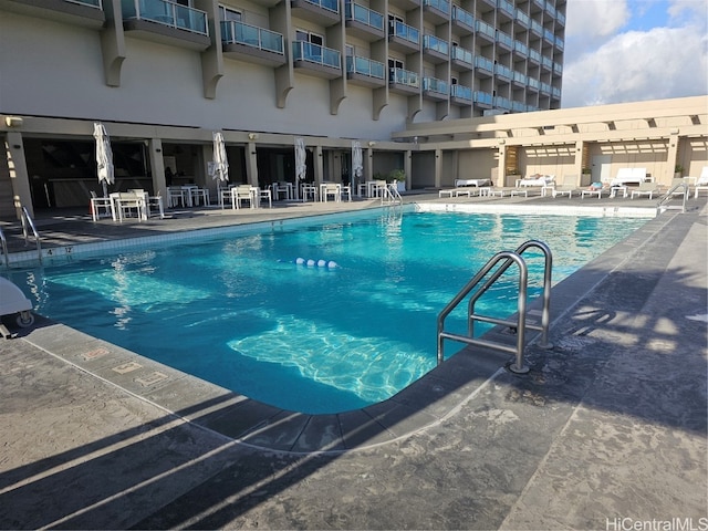 view of swimming pool with a patio area