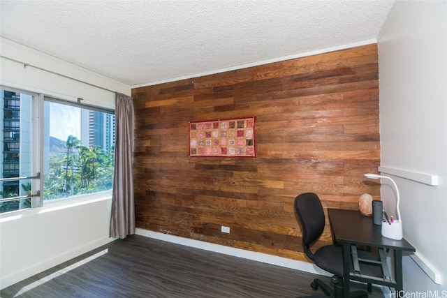 unfurnished office with a textured ceiling, dark hardwood / wood-style floors, and wood walls