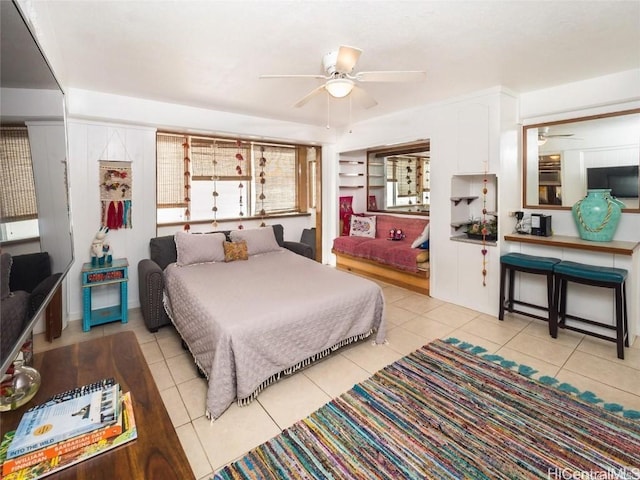 bedroom with ceiling fan and light tile patterned floors