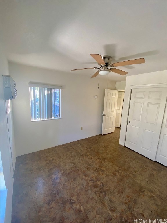 unfurnished bedroom featuring a closet and ceiling fan