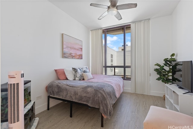 bedroom with light hardwood / wood-style floors and ceiling fan