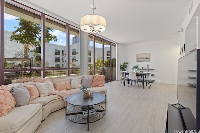 living room with light hardwood / wood-style flooring and a wall of windows