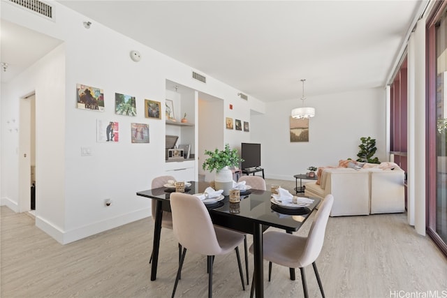 dining space featuring light wood-type flooring