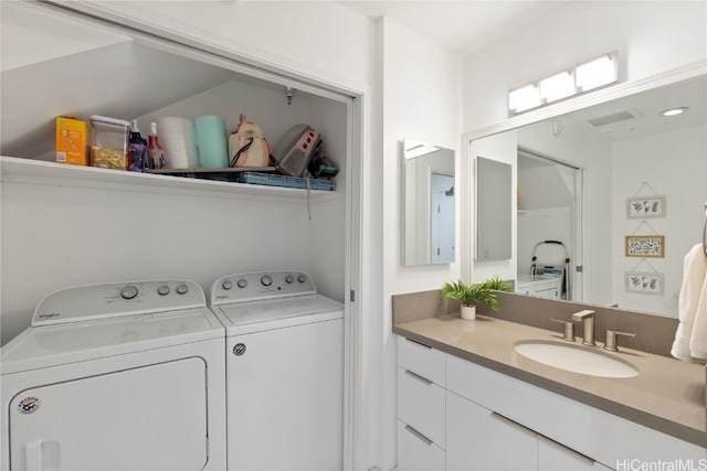 laundry area with washing machine and dryer and sink