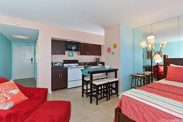 bedroom featuring sink and light tile patterned flooring