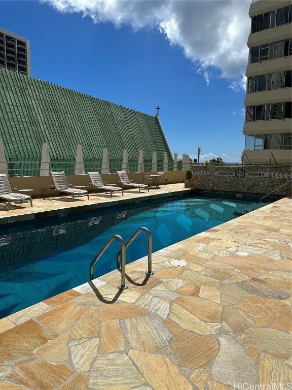 view of swimming pool featuring a patio area