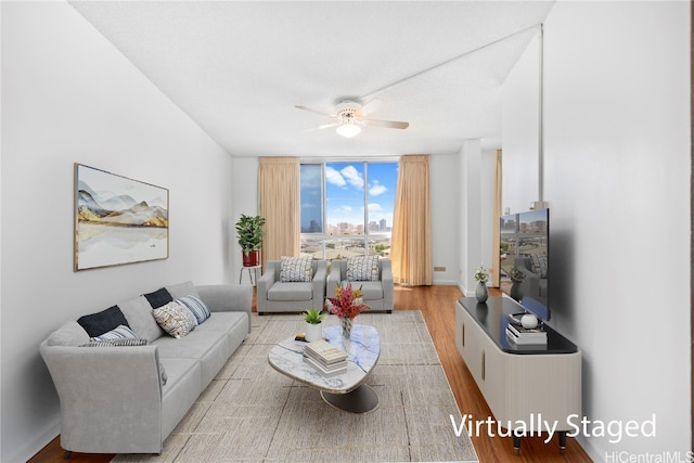 living room with light hardwood / wood-style flooring, floor to ceiling windows, and ceiling fan