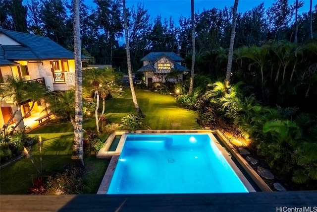 view of pool featuring a yard