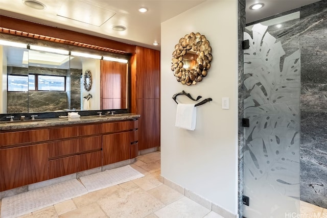 bathroom with vanity and a shower with shower door