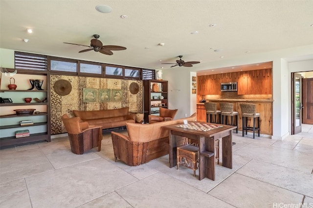 living room featuring a textured ceiling and ceiling fan