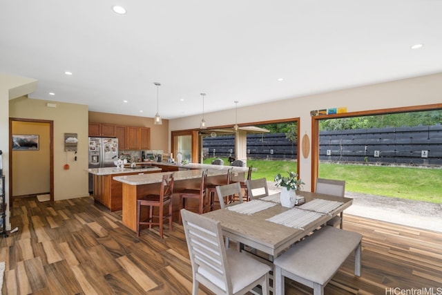 dining room with plenty of natural light and dark hardwood / wood-style flooring