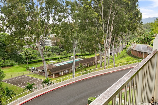 view of home's community featuring a swimming pool and a lawn