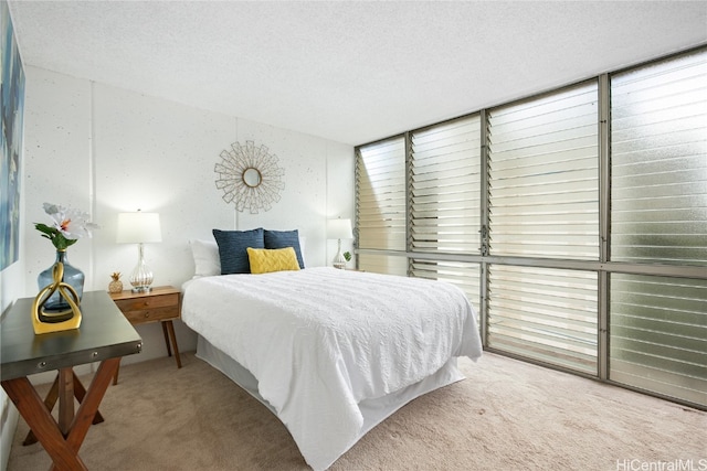 carpeted bedroom featuring a textured ceiling