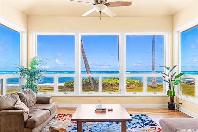 sunroom / solarium with a water view and a healthy amount of sunlight