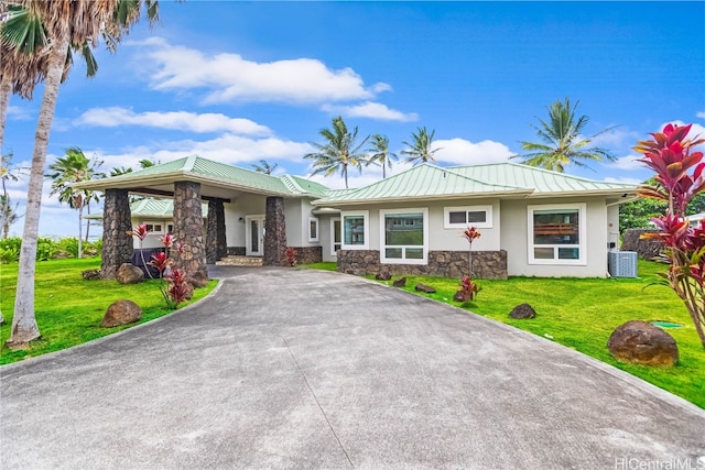 view of front of house featuring a front yard and cooling unit