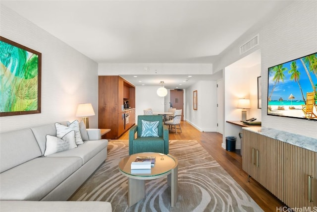 living room with visible vents and wood finished floors