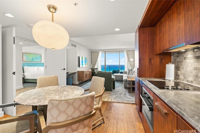 dining space featuring recessed lighting and light wood-type flooring