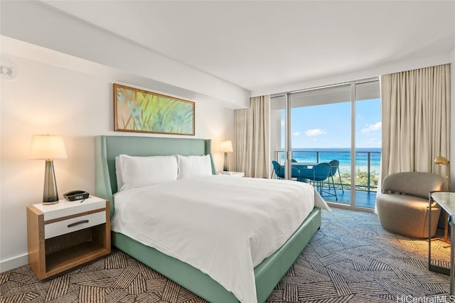 carpeted bedroom with a wall of windows, access to outside, baseboards, and a water view