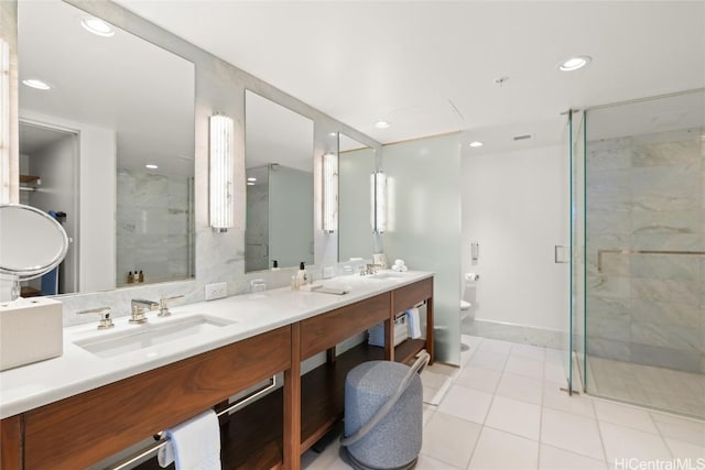 bathroom featuring a marble finish shower, recessed lighting, toilet, and a sink