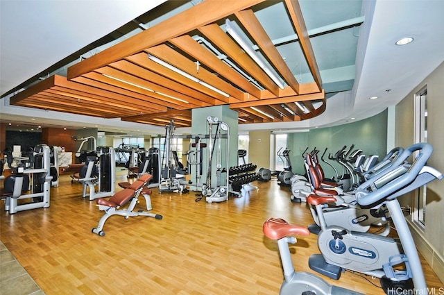 exercise room with wood-type flooring