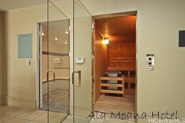 view of sauna with hardwood / wood-style floors, wood ceiling, and wooden walls