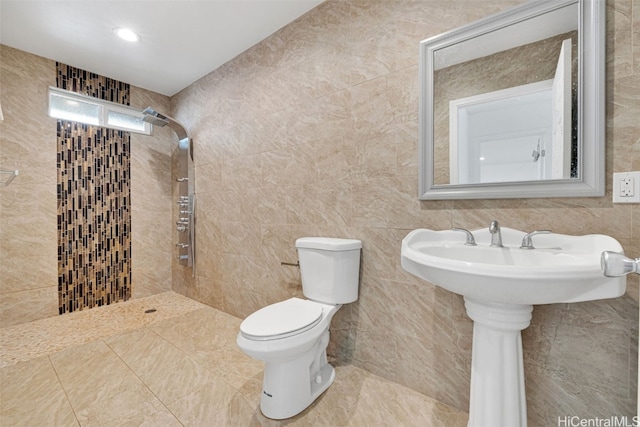 bathroom featuring toilet and tile walls