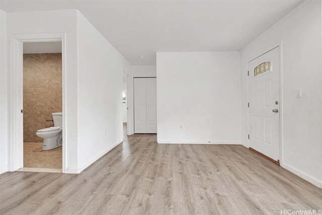 interior space with tile walls and light wood-type flooring