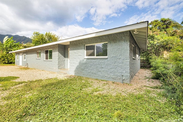 exterior space with a yard and a mountain view