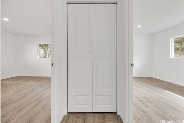 hallway with light hardwood / wood-style floors