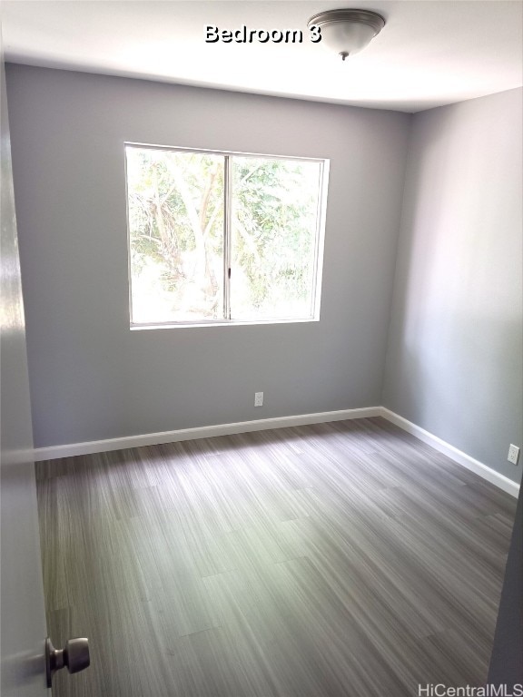 empty room featuring dark hardwood / wood-style floors