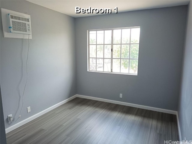 91-1021 Kuina St Unit 119, Ewa Beach, HI 96706 - spare room with baseboards, wood finished floors, and a wall unit AC