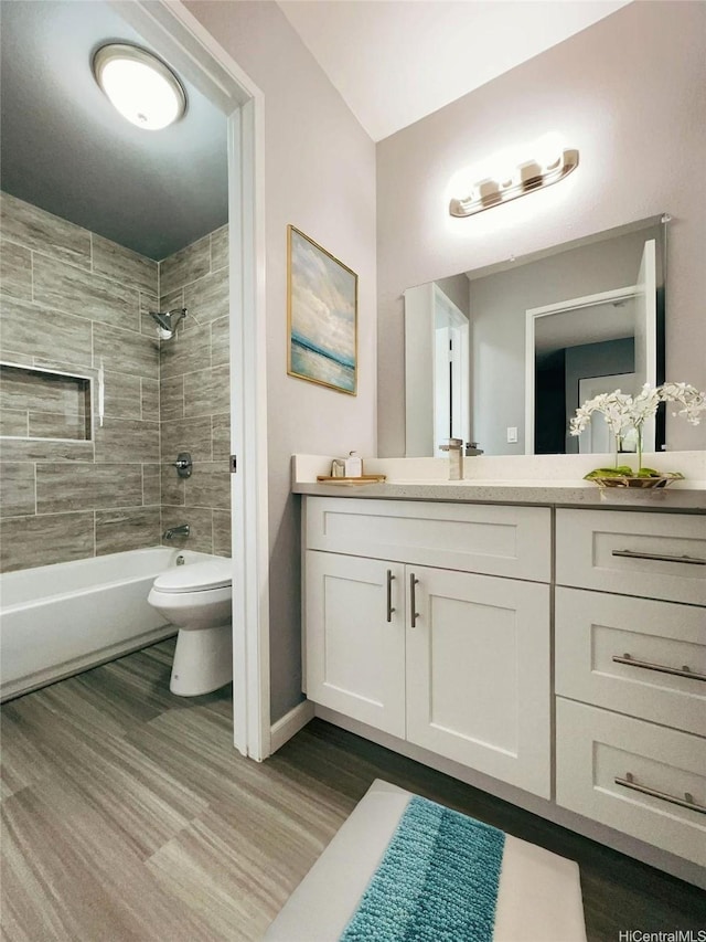 91-1021 Kuina St Unit 119, Ewa Beach, HI 96706 - bathroom featuring wood finished floors, toilet, vanity, baseboards, and shower / bathing tub combination