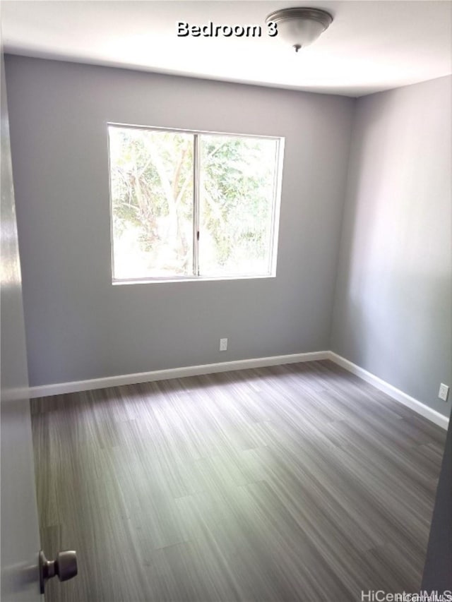 91-1021 Kuina St Unit 119, Ewa Beach, HI 96706 - spare room with dark wood-style floors and baseboards