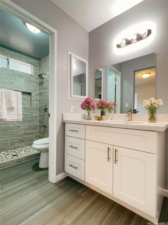 91-1021 Kuina St Unit 119, Ewa Beach, HI 96706 - full bath featuring wood finished floors, toilet, vanity, baseboards, and tiled shower