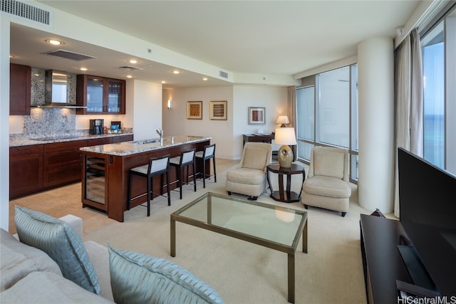 living room featuring wine cooler and sink