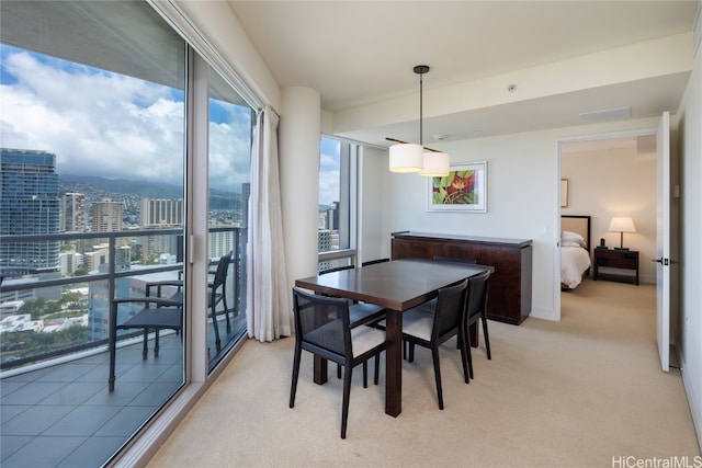 dining area featuring light colored carpet