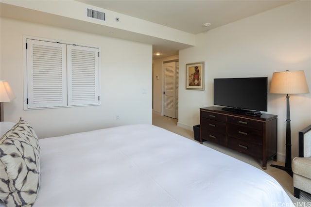 bedroom with a closet and light carpet