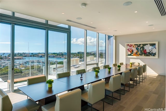 dining space with expansive windows and hardwood / wood-style floors