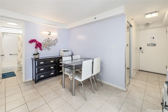 dining space featuring light tile patterned floors