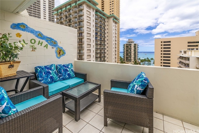 balcony with an outdoor hangout area and a water view