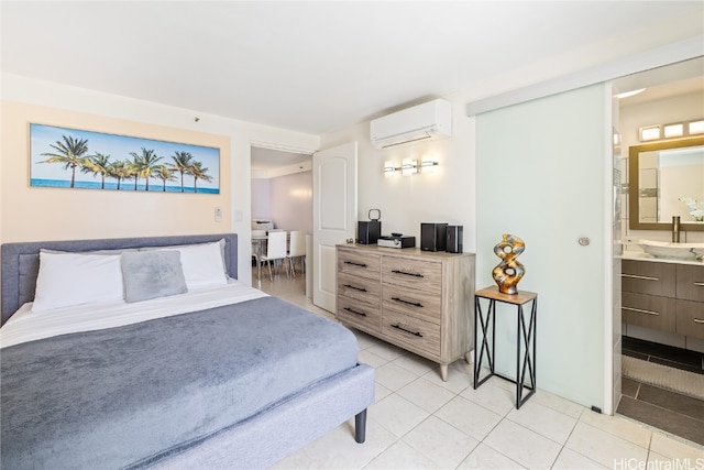 tiled bedroom featuring a wall unit AC, sink, and connected bathroom