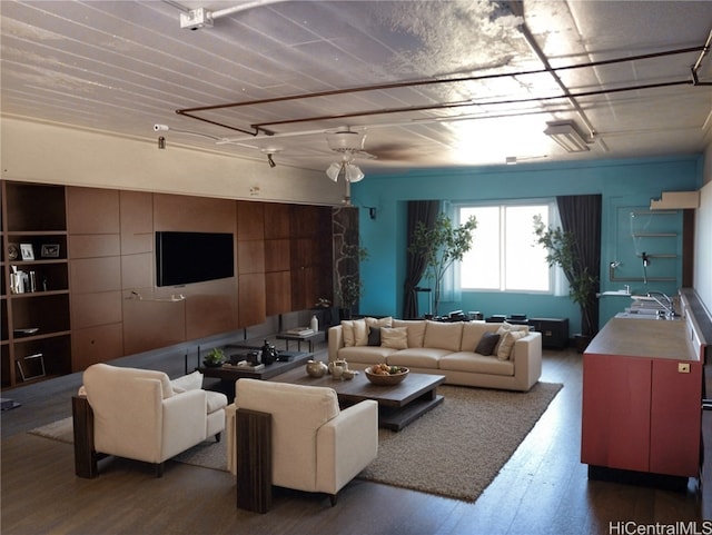 living room with dark wood-type flooring, ceiling fan, and sink