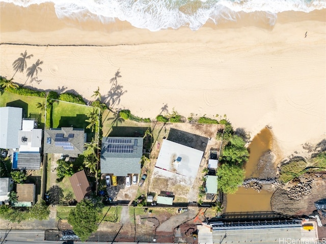 birds eye view of property featuring a water view and a beach view