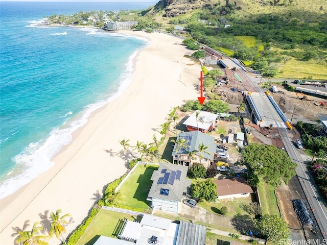 aerial view with a water view and a beach view