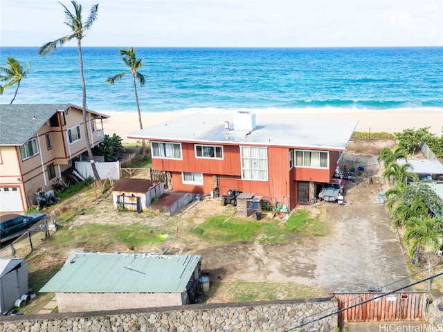 drone / aerial view featuring a water view and a beach view