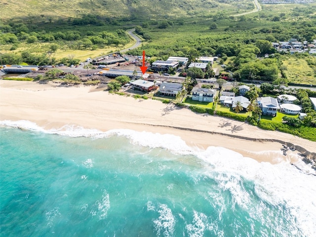 drone / aerial view featuring a water view and a view of the beach