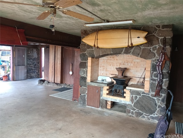 interior space with concrete floors and ceiling fan