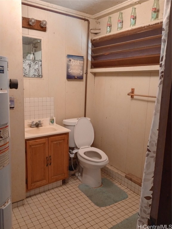 bathroom with toilet, tile patterned flooring, water heater, vanity, and wood walls