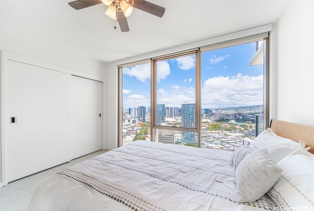 carpeted bedroom with a closet and ceiling fan