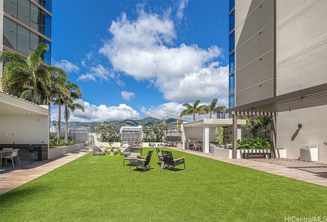 view of yard featuring a mountain view and a patio